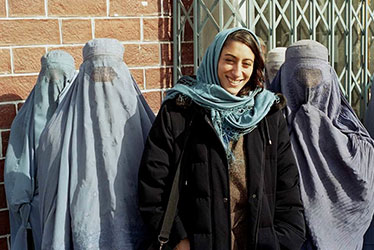 Journalist Ilene Prusher with women in burqas in Kabul, Afghanistan