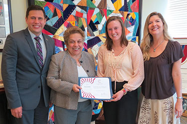 President Donna E. Shalala presents the 2015 Newman Civic Fellows Award to Natasha Koermer